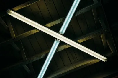 Two overhead fluorescent lights crossed in an X shape